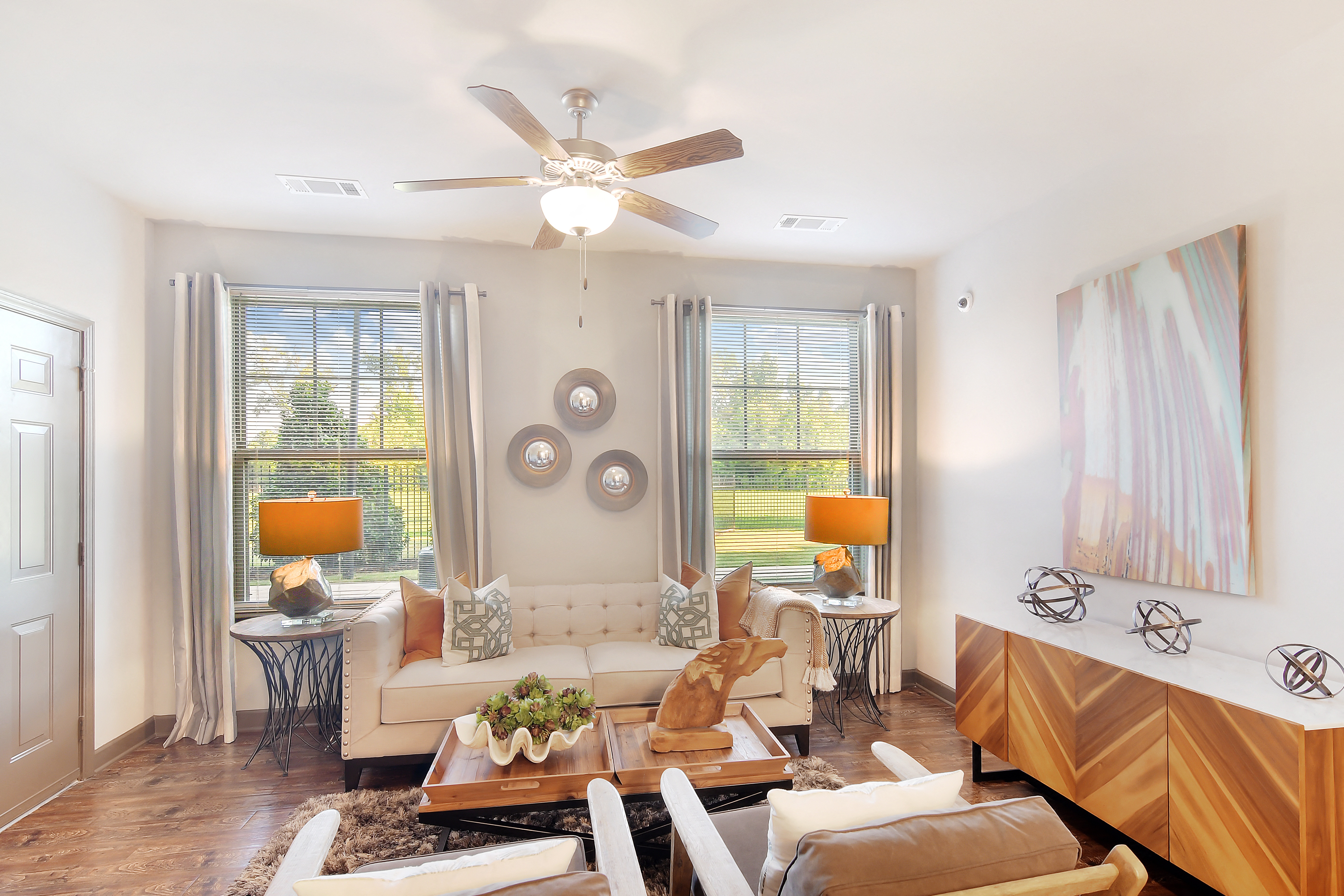 a living room with a ceiling fan and a couch